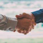 background image of the handshake of business partners in the office. business concept